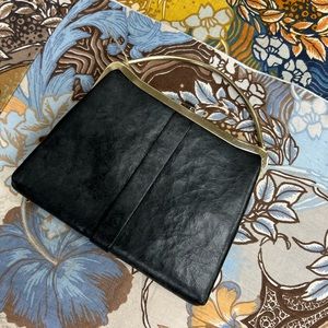 Vintage black leather clutch with a gold handle